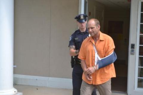 Jefferson Davis Eames was led out of East Hampton Town Justice Court after being sentenced to eight months in county jail.