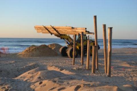 Piles are being driven for wooden access walks that will traverse the sandbag seawall being built on the downtown Montauk beach.