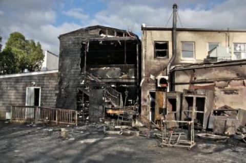 While Friday's fire began in a refrigeration unit behind Rowdy Hall in East Hampton Village, it was the building to the south, which housed J. Crew, that suffered the most damage. While Friday's fire began in a refrigeration unit behind Rowdy Hall in East Hampton Village, it was the building to the south, which housed J. Crew, that suffered the most damage.