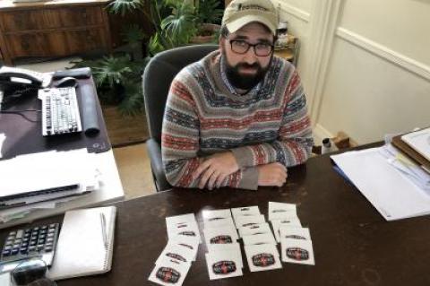Joshua Borsack, at his desk at Strong Insurance Agency in East Hampton, showed just a fraction of the gift cards he and his wife, Summer Borsack, have collected for Coast Guard members stationed in Montauk. Joshua Borsack, at his desk at Strong Insurance Agency in East Hampton, showed just a fraction of the gift cards he and his wife, Summer Borsack, have collected for Coast Guard members stationed in Montauk.