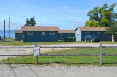 All four of the small cottages overlooking Fort Pond Bay are to be knocked down to make way for three larger resort units built of steel, glass, and mahogany.