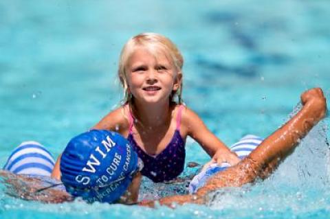 A river raft race — see Heather Caputo and her 4-year-old daughter, Annabelle, above — was one of several offbeat events Tim Treadwell mixed in with 50 to 200-yard age-group races at Bill and Dominique Kahn’s pool Saturday.