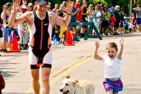 Evan Drutman, who placed fifth in the 50-to-54-year-old group, crossed the finish line with his 4-year-old daughter, Natalie, and his 12-year-old Lab, Glory.