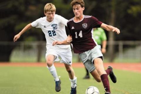 A goal by Zane Musnicki, at right, shown in earlier-season action, earned East Hampton a playoff berth at Wyandanch Friday.