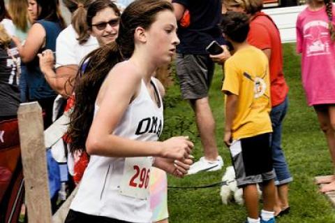 Ava Engstrom, above, and 11 other girls are on Yani Cuesta’s winter track team, which the coach says is “off to a great start.”