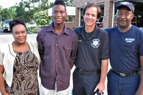 Jerome Walker Jr. weighed just 1 pound 9 ounces and was not breathing when he was born on July 4, 1996, three months premature. At his high school graduation last month, he met the volunteer first responder who helped deliver him, Philip Cammann, for the first time. His parents, Penny Walker, left, and Jerome Walker Sr., right, credit Mr. Cammann with saving his life.  	Walker Family, Jerome Walker Jr. weighed just 1 pound 9 ounces and was not breathing when he was born on July 4, 1996, three months premature. At his high school graduation last month, he met the volunteer first responder who helped deliver him, Philip Cammann, for the first time. His parents, Penny Walker, left, and Jerome Walker Sr., right, credit Mr. Cammann with saving his life.  	Walker Family,