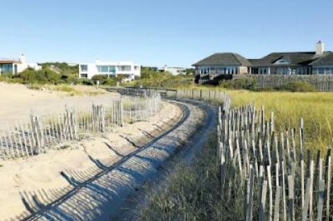 A truck path through the dunes at the end of Marine Boulevard in Beach Hampton is at issue in a suit by neighbors who oppose the expansion of beach driving there in recent decades. A truck path through the dunes at the end of Marine Boulevard in Beach Hampton is at issue in a suit by neighbors who oppose the expansion of beach driving there in recent decades.