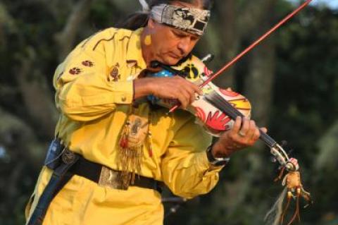 Arvel Bird playing violin at the Shinnecock Powwow