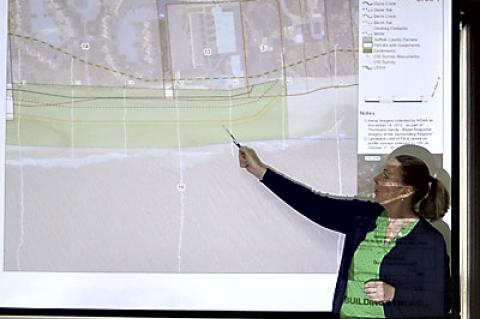 Sue McCormick of the New York State Department of Environmental Conservation pointed out the boundaries of a downtown Montauk dune-building project proposed by the Army Corps of Engineers at a meeting last week. Sue McCormick of the New York State Department of Environmental Conservation pointed out the boundaries of a downtown Montauk dune-building project proposed by the Army Corps of Engineers at a meeting last week.