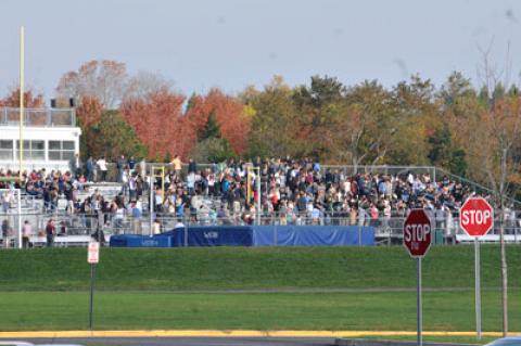 East Hampton High School students were ushered to the bleachers by the football field during an evacuation of the building after a scrawled threat was discovered yesterday morning. East Hampton High School students were ushered to the bleachers by the football field during an evacuation of the building after a scrawled threat was discovered yesterday morning.
