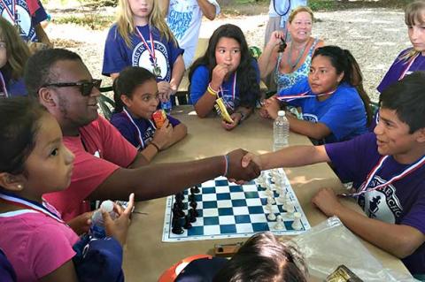 A handshake between Morgan Brown, left, and Alex Vanegas, right, symbolized the start of a championship chess game on Tuesday morning near the end of the first-ever Chess in the Schools tournament on Long Island at the LongHouse Reserve. A handshake between Morgan Brown, left, and Alex Vanegas, right, symbolized the start of a championship chess game on Tuesday morning near the end of the first-ever Chess in the Schools tournament on Long Island at the LongHouse Reserve.