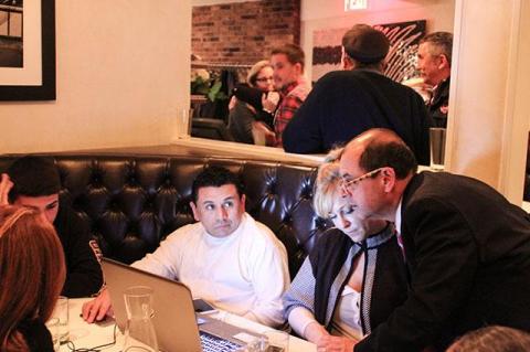 At Cittanuova in East Hampton on Tuesday night, Manny Vilar, right, the Republican candidate for supervisor, peered at a computer screen as election results began to indicate that his prospects of success were dwindling.