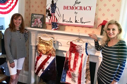 Nicole Miller, with Pamela Wright, right, co-founder of the Museum of Democracy, sold one of these hand-painted paper dresses over the weekend at her pop-up shop in the Bridgehampton Museum.