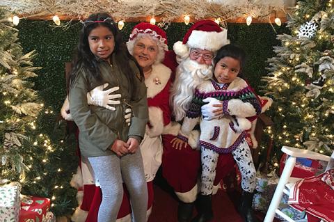 Mr. and Mrs. Claus (a.k.a. Bonnie and Stan Morlando) with 9-year-old Emely and 5-year-old Kailyn Urgiles at the Snow Village at Groundworks Landscaping in East Hampton. “I want a pony for Christmas,” Kailyn said. Mr. and Mrs. Claus (a.k.a. Bonnie and Stan Morlando) with 9-year-old Emely and 5-year-old Kailyn Urgiles at the Snow Village at Groundworks Landscaping in East Hampton. “I want a pony for Christmas,” Kailyn said.