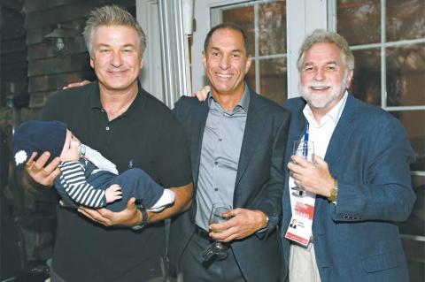 Alec Baldwin, holding his son Rafael, at last year’s Hamptons International Film Festival with Stuart Match Suna and Randy Mastro, right. It was during last year’s festival that Mr. Baldwin and Mr. Mastro became co-chairmen after Mr. Suna’s retirement.