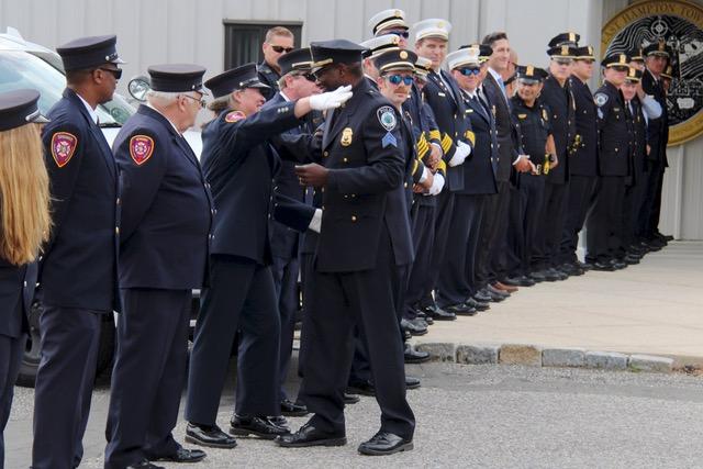 Barry Johnson got a hug from a fellow member of the Springs Fire Department, which joined the line at his ceremonial walkout at town police headquarters on Monday.